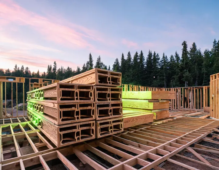Engineered wood I-joists staged on a residential framing jobsite